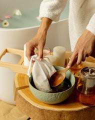 An inviting spa scene with Bath Tea Blend that is prepared before pouring into the tub, highlighting a luxurious home spa for a rejuvenating experience.