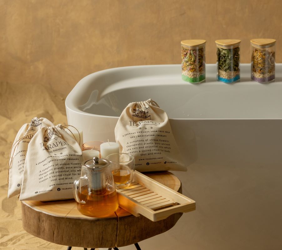  A calming bathtub setup with a bag of herbal soap and a wooden tray, designed for a rejuvenating and luxurious bath experience.